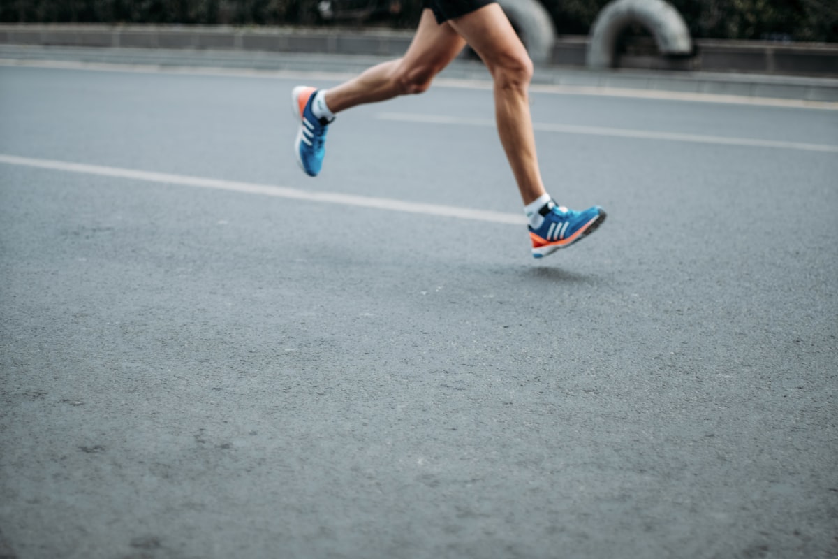 Runner in motion on an open road